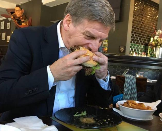 Bill English declared the burger "juicy and "sophisticated". Photo: NZ Herald