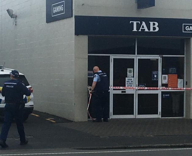 Police put up tape at the scene of the second robbery in South Dunedin today. Photo: Hamish...
