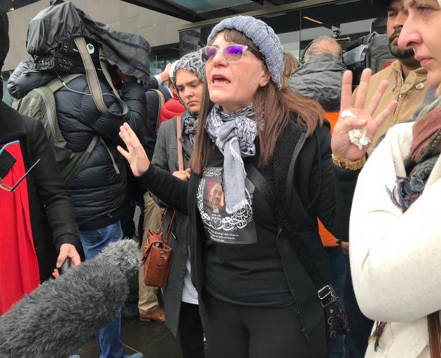 Janna Ezat, wearing a T-shirt in memorial of her son who was killed at Al Noor mosque on March 15, reacts outside the Christchurch High Court after the accused gunman pleaded not guilty to all charges. Photo: Reuters