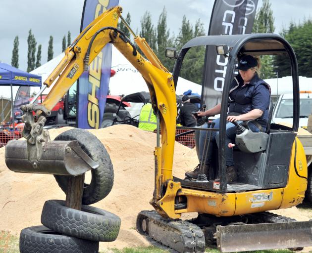 Ann Linton takes part in the mini digger section at the Young Farmer of the Year Otago district...