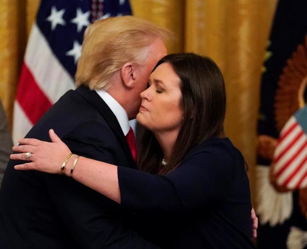 Donald Trump embraces Sarah Sanders at the White House. Photo: Reuters 