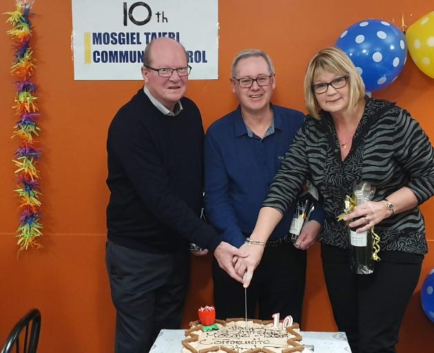 Cutting a cake at the celebration of the 10th anniversary of the Mosgiel-Taieri Community Patrol...
