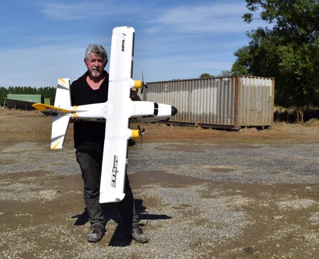 Dunedin Model Aero Club president Jeff Smart in the boggy, flood-damaged club grounds near Outram...