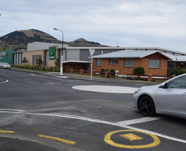 A motorist stops in the middle of a new roundabout to check for oncoming traffic at the...