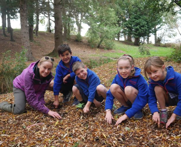 Dr Cynthia Winkworth, of Catchments Otago, and Abbotsford School pupils (from left) Tane Paiur,...