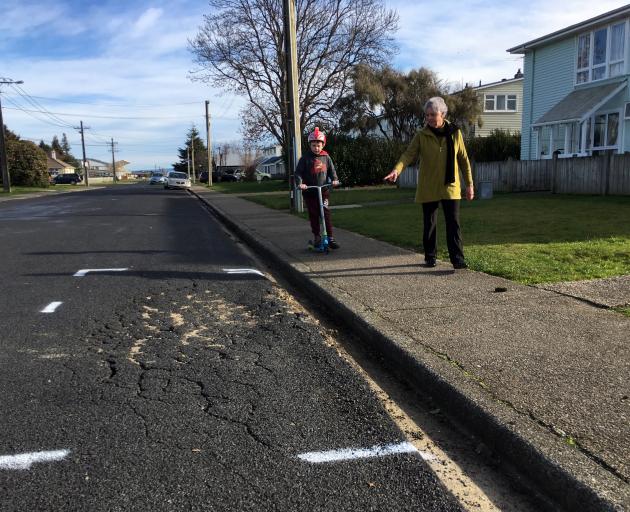 Jean Brown, of Mosgiel, points out damaged road seal to her grandson Jaxon McKay (8), of...