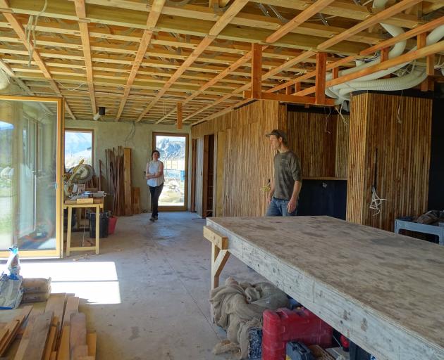 Jessica and Ben Eyers in the main room of their yet to be certified passive straw bale house.