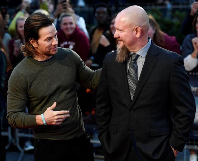 Actor Mark Wahlberg poses alongside Mike Williams one of the victims of the 2010 oil rig disaster...