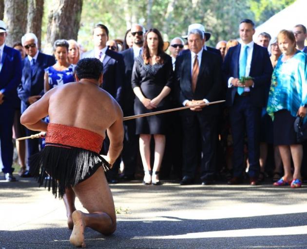 Prime Minister Jacinda Ardern (centre) and other party leaders are welcomed at Waitangi this...