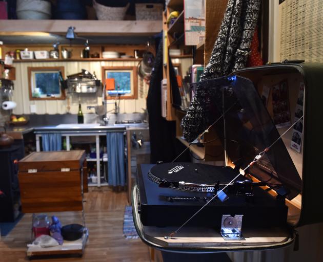 An old suitcase on one wall zips apart to reveal a record player.







