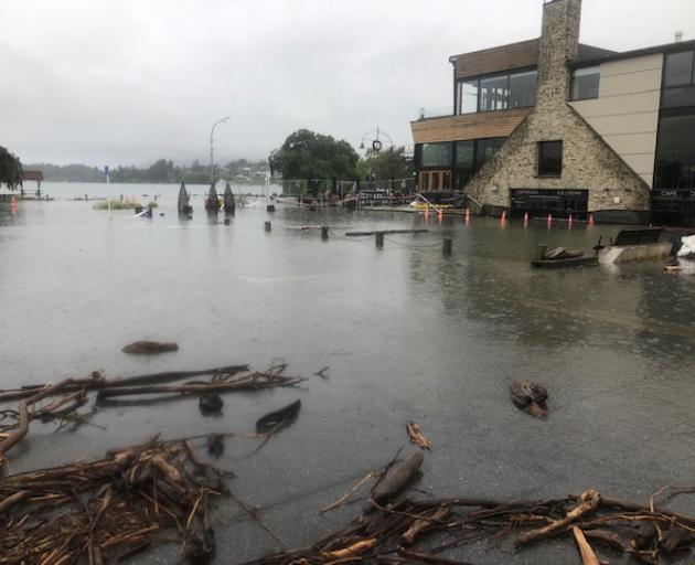 Water laps near businesses on the waterfront in Wanaka on Sunday morning. Photo: Kerrie Waterworth