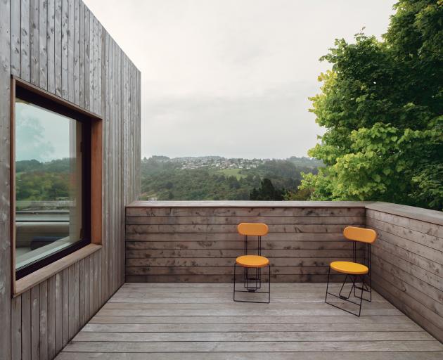 The outdoor terrace sits among the garden’s mature tree canopy.