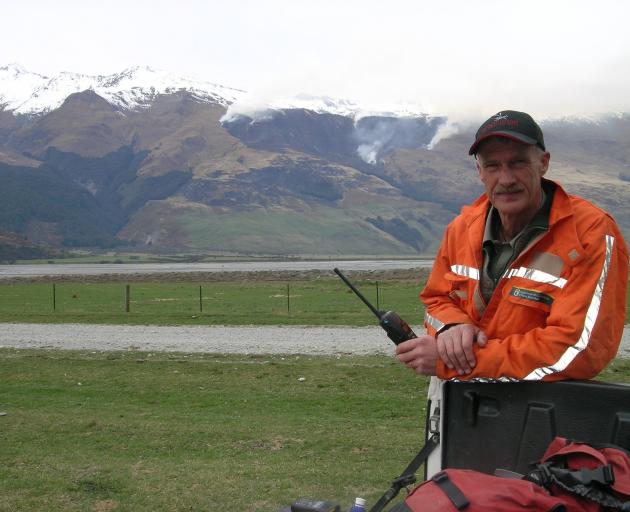Wanaka Doc rural fire officer Paul Hondelink in the Matukituki Valley in 2007, with the West Wanaka Station fire in the background. Photo: ODT