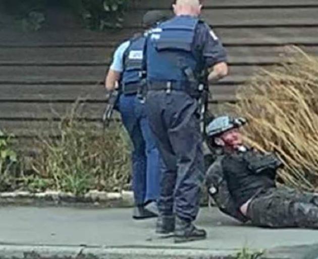 The moment the accused Christchurch mosque gunman was dragged from his car and arrested. Photo:...