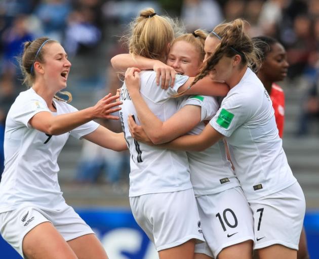 New Zealand's Grace Wisnewski (centre) of celebrates scoring a goal with her teammates against...