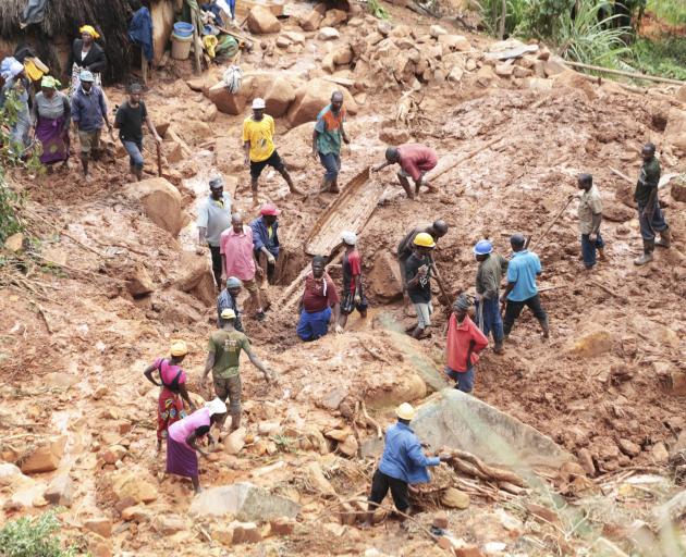 A family dig for their son who got buried in mud when the cyclone struck Chimanimani in Zimbabwe....