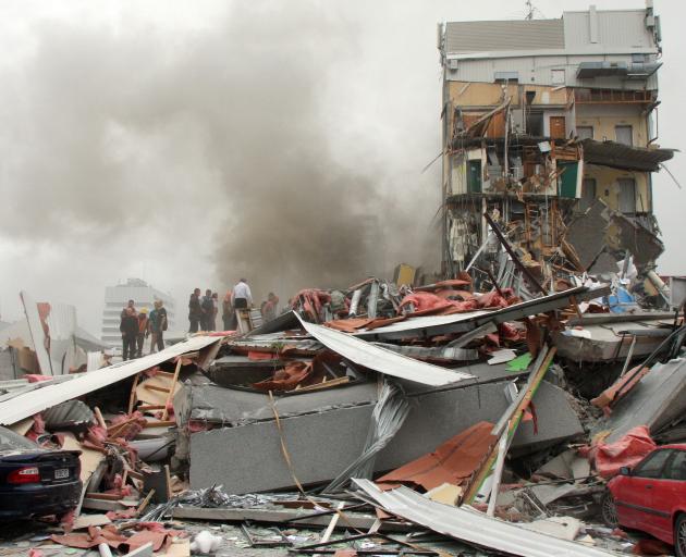 Police and volunteers work to rescue people trapped in the collapsed CTV building. Photo: Star News 