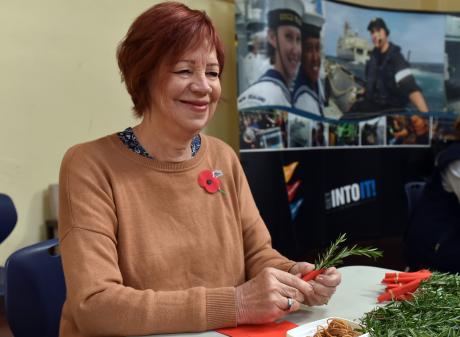 Volunteer Evelyn McDowall makes posies for Anzac Day, at HMNZS Toroa in Dunedin, yesterday. PHOTO...