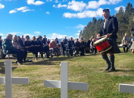 A drummer and bagpiper perform during the Oturehua Anzac service, in front of about 40 people....