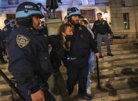 New York Police Department officers enter the Columbia University building and detain pro...