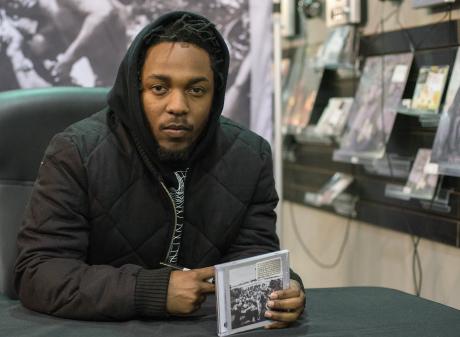 Kendrick Lamar signs copies of his album To Pimp A Butterfly in 2015. PHOTO: GETTY IMAGES