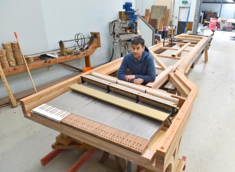 Dunedin piano builder Adrian Mann sits at one of two Alexander pianos he is building for a buyer...