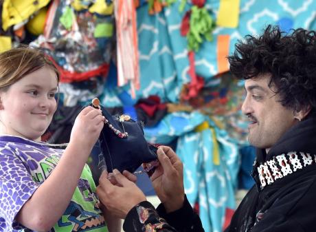 Port Chalmers School student Madeleine Trist Rickerby, 10, shows artist Beau Cotton, who is...