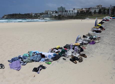 Belongings left behind by people are gathered at the beach near the scene of a shooting during a...