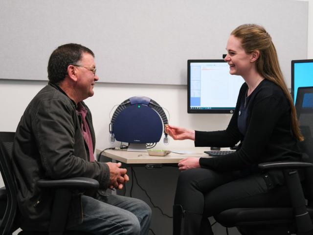 Dunedin Audiologist Rachel Barker discusses hearing aid options with her client