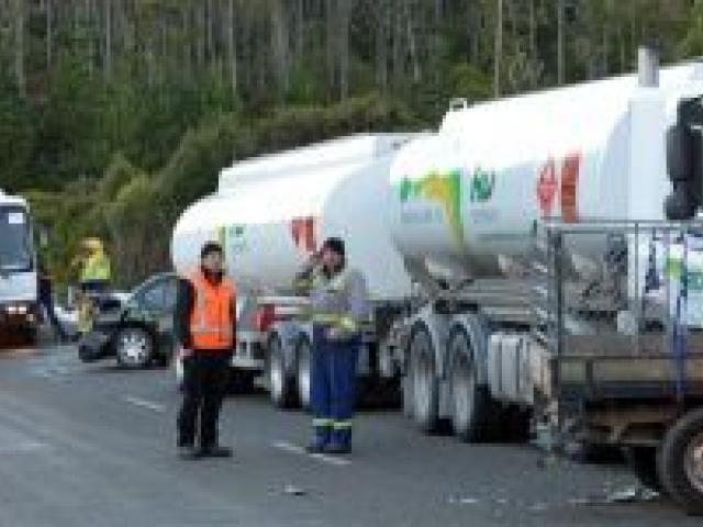 Traffic comes to a halt on the Northern Motorway yesterday morning after a crash involving a ute, a petrol tanker, a car and a bus. Photos by Stephen Jaquiery.