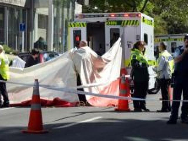 Emergency services work at the scene of a fatal crash in Cumberland St, outside Dunedin Hospital, yesterday. Photo by Peter McIntosh.