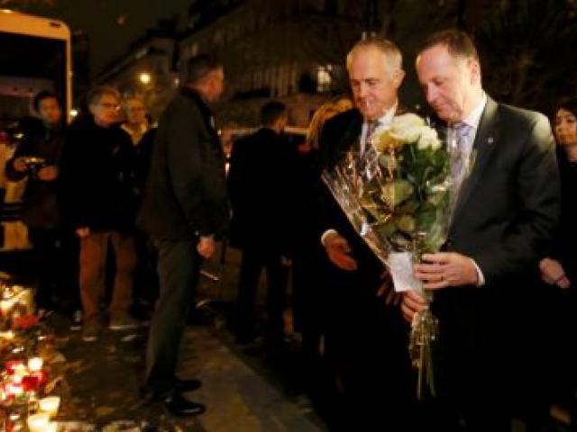 John Key (R)  and Malcolm Turnbull arrive with flowers at the Bataclan concert hall. Photo Reuters