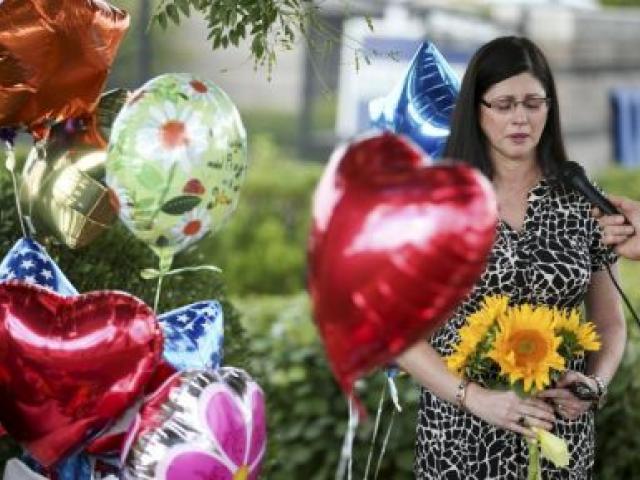  A woman is overcome with emotion as she speaks with a journalist outside the offices of WDBJ7 in Roanoke, Virginia. REUTERS/Chris Keane