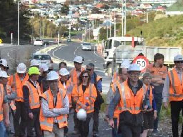 New Zealand Transport  Agency project manager Simon Underwood (fifth from the right) leads a group of  Institution of Professional Engineers New Zealand  members towards the nearly complete Lookout Point Bridge. Photo by Gregor Richardson.