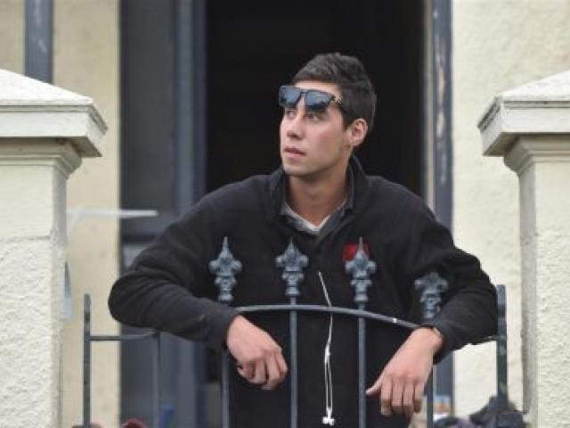 Hyde St resident Reuben Sandoy (20) looks up at a CCTV camera which the University of Otago has pointed at the notorious party street. Photo by Peter McIntosh.