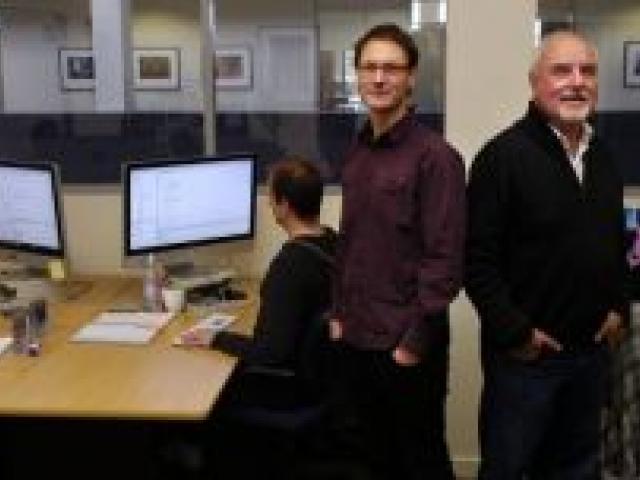 Runaway Play director Tim Nixon (standing, left) and NHNZ general manager John Crawford with game programmers Jeff Laird, Mark van Rij and Emma Johansson at work. Photo by Jane Dawber.