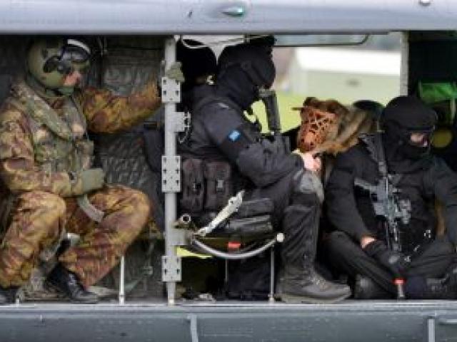 Armed offenders squad members and Royal New Zealand Air Force personnel prepare to leave Taieri airfield for an undisclosed location on the Taieri.  Photo by Stephen Jaquiery.