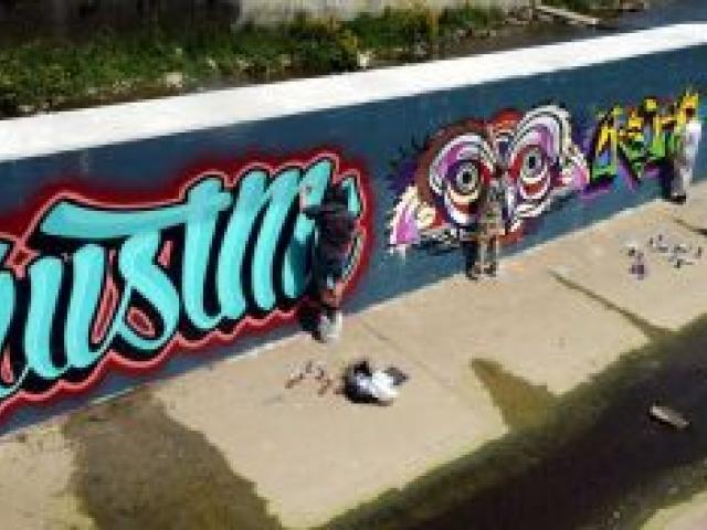 Artists paint a mural this week on a wall in the Water of Leith, without Otago Regional Council permission. Photo by Peter McIntosh. Artists paint a mural this week on a wall in the Water of Leith, without Otago Regional Council permission. Photo by Peter McIntosh.
