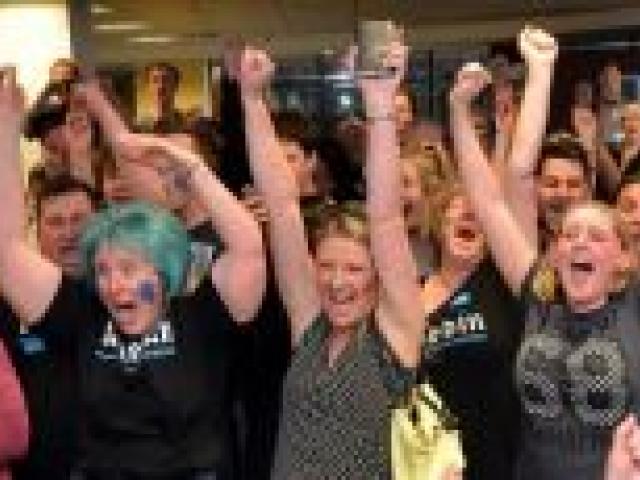 Gigatown supporters cheer Dunedin's success in the competition at the city's Gigatown office in George St last night. Photo by Peter McIntosh.