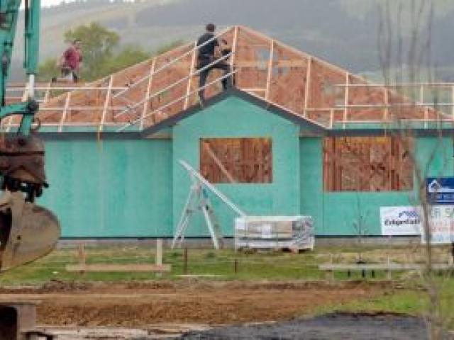 Scaffolders work on a house in the Highland Park subdivision in Mosgiel.  Photo by Stephen Jaquiery.