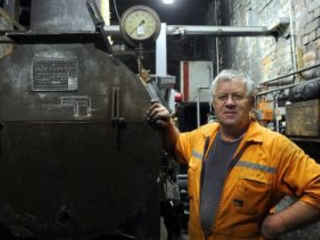 Dunedin Gasworks Museum engineering team co-ordinator Tom Galletly stands beside the earlier 1960s smokebox, now attached to a new oil-fired boiler. Photo by Craig Baxter.