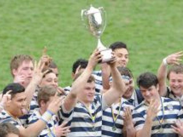 Otago Boys' High School players celebrate a fourth straight Highlanders First XV title at Littlebourne on Saturday. Photo by Peter McIntosh.