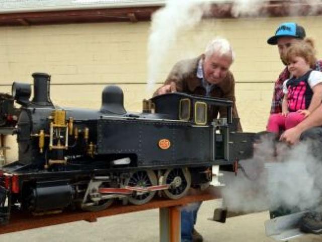 Otago Model Engineering Society life member Des Burrow (84) prepares his model steam engine for a ride with his grandson Ricky Constable (27) great-granddaughter Tayla Constable (2), in Dunedin yesterday. Photo by Stephen Jaquiery.