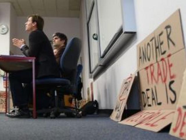 Associate Prof  Nathan Berg (left) speaks about the controversial Trans Pacific Partnership agreement at a University of Otago event yesterday, at which fellow panellists Dunedin city councillor Aaron Hawkins  and (partially obscured) Unions Otago convene