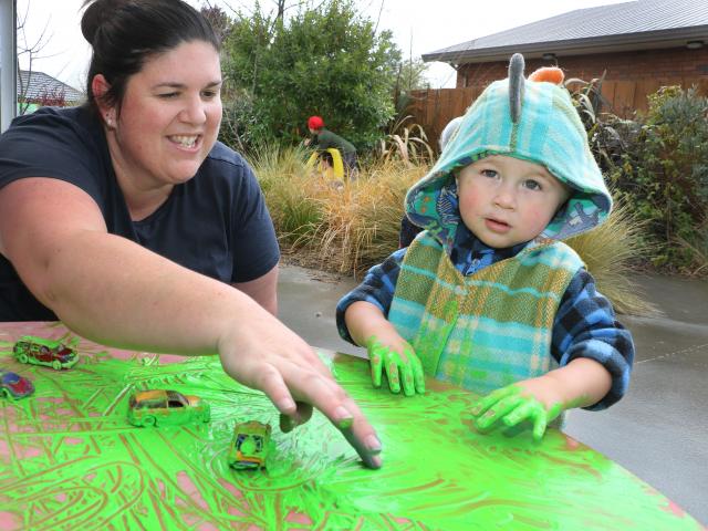 Rangiora Playcentre session facilitator Melissa Brine helps Rocky Thorpe aged 21 months, to play...