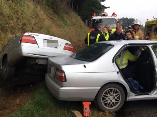 The wreckage of both cars, a silver 1997 Nissan Bluebird and a silver 1999 Nissan Bluebird, lay on the northbound side of the road, one of them in a ditch. Photo: Supplied The wreckage of both cars, a silver 1997 Nissan Bluebird and a silver 1999 Nissan Bluebird, lay on the northbound side of the road, one of them in a ditch. Photo: Supplied