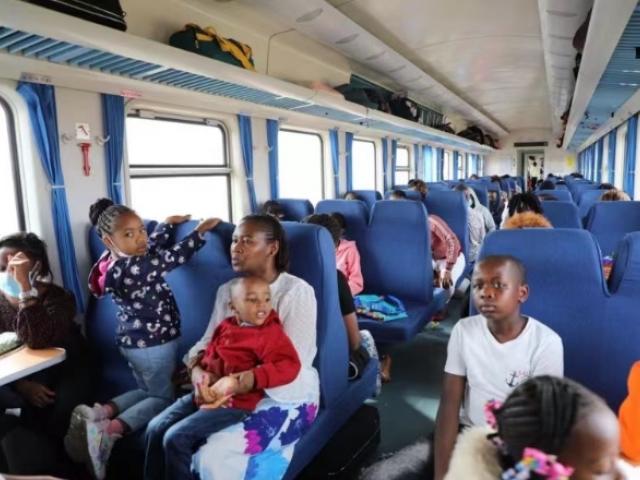 Passengers are seen onboard the train to Mombasa at the Nairobi station of the Mombasa-Nairobi...
