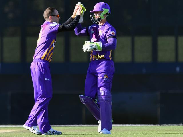 Cam Fletcher denies Todd Astle a touch of his purple helmet.