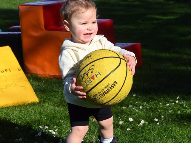 Theodora Paulino, 15 months, of Dunedin, grabs hold of a basketball. 