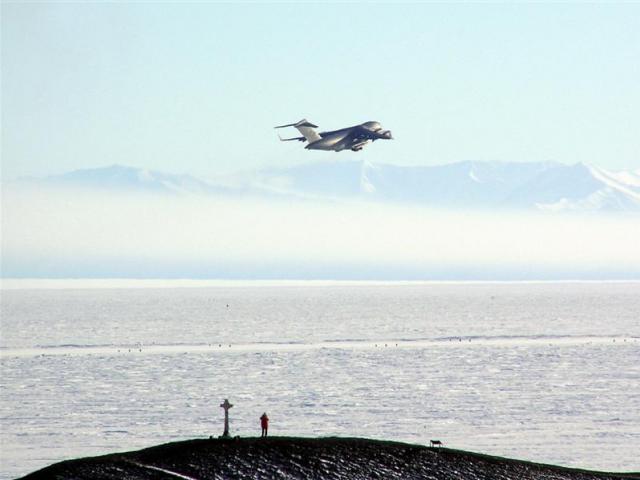 A C17 Globemaster leaves McMurdo Station for Christchurch. Vince's Cross and Hut Point are in the...